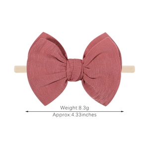 Elastic baby headband with dark pink knitted bow hair accessory for infants