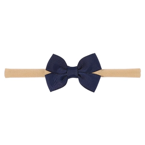 Detail of navy blue grosgrain ribbon bow on high-elasticity nylon headband for infants