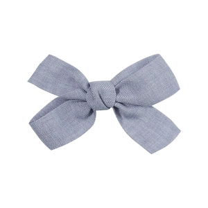 Detail showing the linen texture and stitching of this light blue fabric bow hair clip