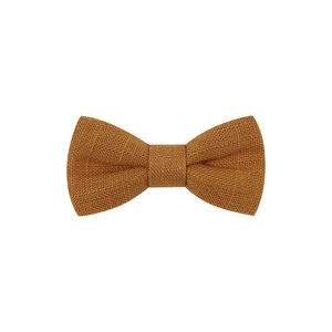 Close-up of mustard yellow fabric bow clip showing detailed linen texture and weave