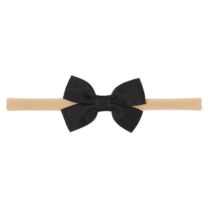 Detail of handmade black grosgrain ribbon bow on a soft nude high-elastic nylon baby headband