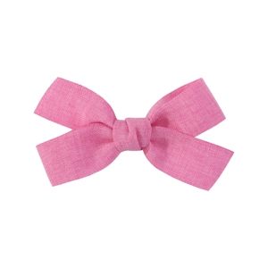 Handmade pink fabric bow hair clip for girls with textured linen material on white background