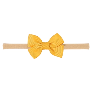 Detailed view of handmade ginger yellow ribbed ribbon bow on soft nylon baby headband