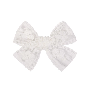 Detailed view of white lace bow hair clip featuring delicate floral embroidery texture