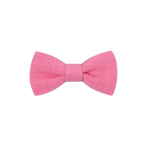 Close-up detail of the pink fabric bow hair clip showing textured cross-weave material