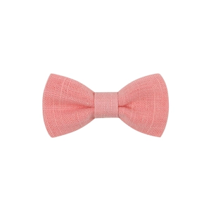 Close-up of pink fabric bow hair clip featuring a textured woven linen material