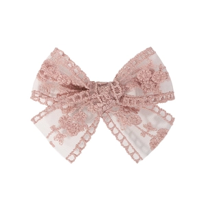 Close-up of pink lace bow hair clip featuring intricate floral embroidery for girls