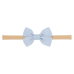 Detailed close-up of light blue grosgrain ribbon bow on a soft nude nylon headband