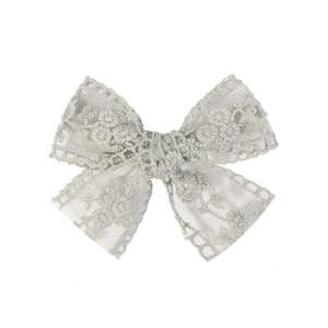 Detailed close-up of grey lace hair clip with floral embroidery and hollow lace edges