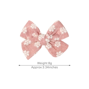 Pink handmade embroidered butterfly bow hair clip for girls with white floral pattern
