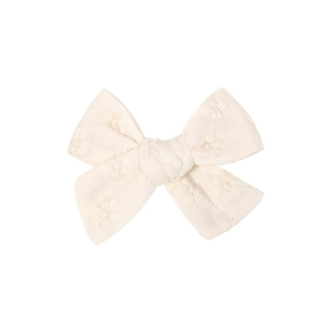 Close-up of cream embroidered fabric bow hair clip showing floral needlework details