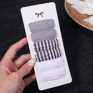 Detail of 6-piece embroidered BB hair clips set in black and white stripes and plaid patterns