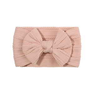 Diadema elástica rosa de punto jacquard para bebé con un lazo grande decorativo