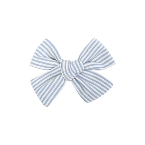 Close-up of a handmade blue and white striped fabric bow hair clip with fine embroidery