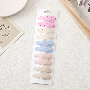 Close-up of 10-piece floral embroidery fabric snap clips set on a display card