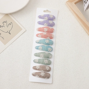 10-piece floral embroidered BB hair clip set for kids with fabric lining on card