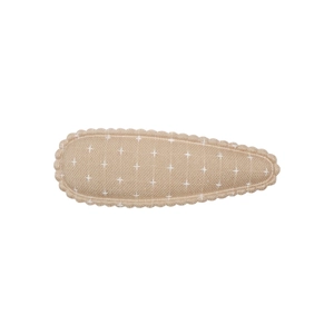 Detail of embroidered teardrop hair clip featuring linen texture and cross-stitch pattern