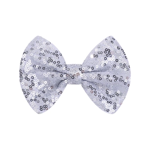 Detail of silver sequined bow clip showing shimmering reflective texture for girls