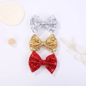 Three-piece set of sequined hair bows for girls in shimmering silver, gold, and red tones