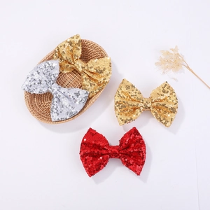 Detailed view of shimmering sequin bows in gold, silver and red for girl hair styling