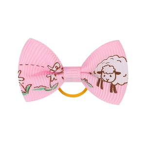 Detail of pink grosgrain bow hair tie featuring cute sheep and floral patterns for girls