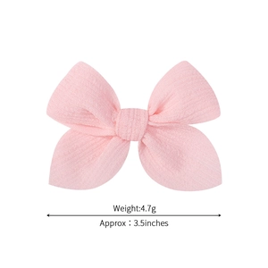 Handmade 3.5 inch pink bow hair clip for girls with a light textured fabric finish