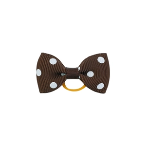 Close-up of brown polka dot grosgrain bow hair tie with a yellow elastic band