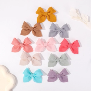 Set of 10 handmade 3.5-inch ribbed fabric bow hair clips in assorted soft pastel colors