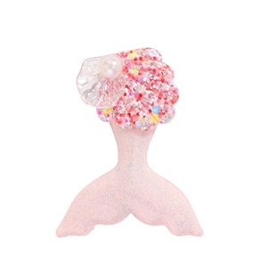 Detail showing pink mermaid tail hair clip with glitter finish, shell and pearl accent