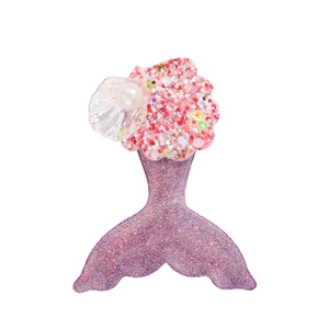 Détail d'une pince à cheveux queue de sirène avec paillettes violettes et perle