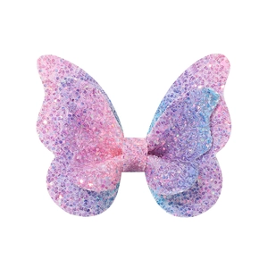 Détail de la pince à cheveux papillon pailletée rose et bleu dégradé pour petites filles