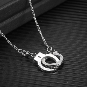 Retro stainless steel necklace featuring engraved Put Down handcuffs on silver chain