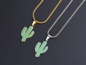 Detail of cactus pendants in gold and silver with green enamel on stainless steel chains
