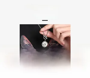 Detailed macro view of rotating smiley face pendant with T-bar clasp on steel necklace