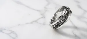 Detail view of titanium steel spinner ring with rotating chain mechanism for stress relief
