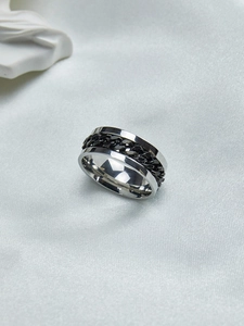 Close-up of rotatable black Cuban chain inlay on a polished silver titanium steel ring