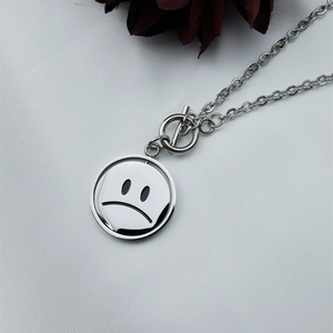 Minimalist spinning smiley face necklace in stainless steel with a stylish toggle clasp