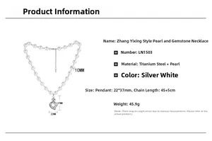 Detailed view of a silver heart-shaped relief pendant on a lustrous pearl necklace chain