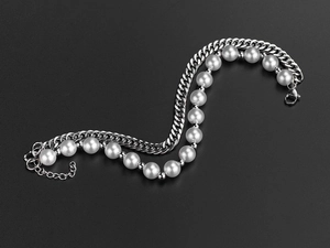 Detail of double-layer hip hop bracelet with silver cuban chain and white pearls