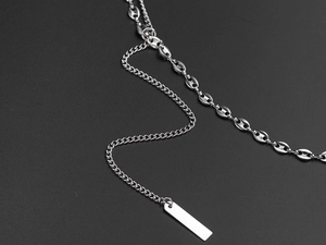 Detail showing mixed chain links with a polished rectangular pendant in silver titanium steel