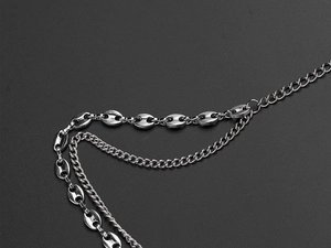 Detailed macro view of silver layered marina and curb chains with metallic luster