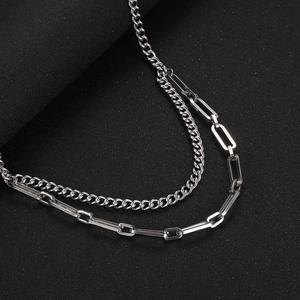 Dettaglio ravvicinato di doppia catena d'argento a maglia barbazzale e graffetta