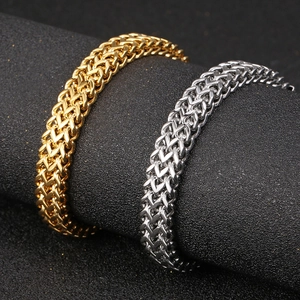 Macro shot of gold and silver Franco chain bracelets showing dual interlocking V-links