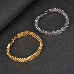 Close-up of gold and silver woven stainless steel chains with secure lobster clasps