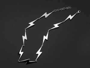 Detailed view of silver polished lightning bolt link necklace with lobster clasp and chain