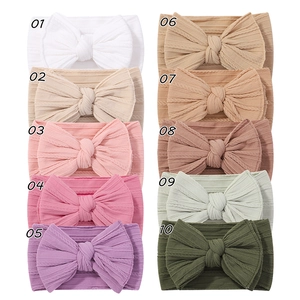 Set of 10 ribbed nylon baby headbands with large bows in assorted colors for infants