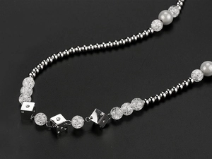 Detail of hip hop stainless steel necklace with metal beads and silver dice pendants