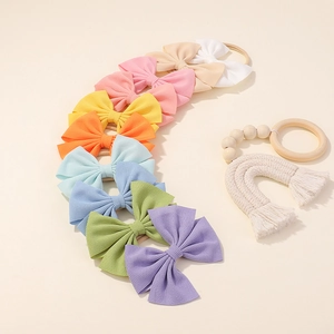 Detail showing 10-pack pastel baby headbands with waffle texture and elastic nylon bands