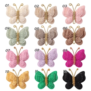 Detail showing 12 colors of knitted butterfly hair clips with gold wire accents