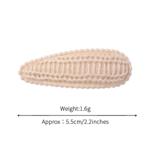 Beige knitted wool BB hair clip for girls with elegant scalloped lace edges on white background